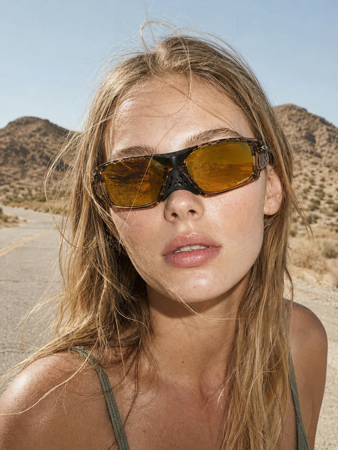 VAELT amber eyewear on an open desert road